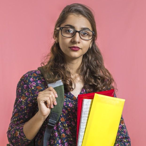 Premium Photo _ Indian girl student in glasses with folders and books